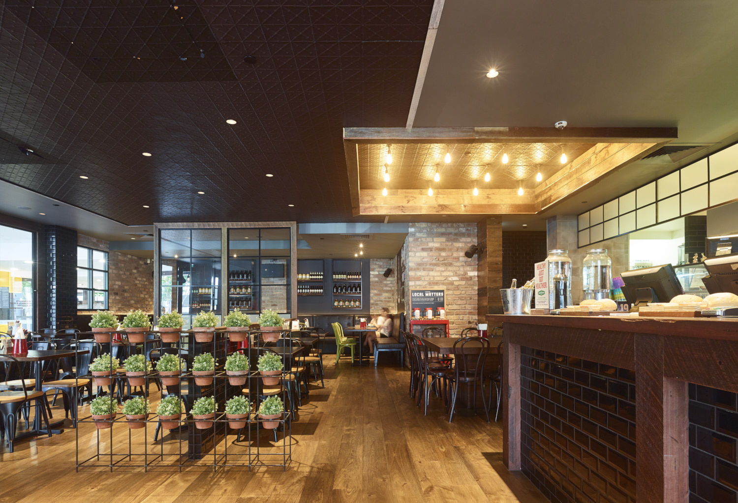 Dining room at Grill'd Toowong with timber tables and warm lighting